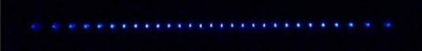 A chain of Th atoms suspended in an RF ion trap.