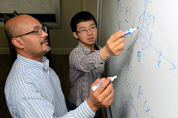 Xiang Yang and Rajat Mittal at a whiteboard