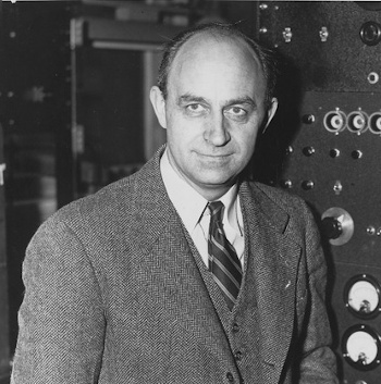 Enrico Fermi at a laboratory control panel.